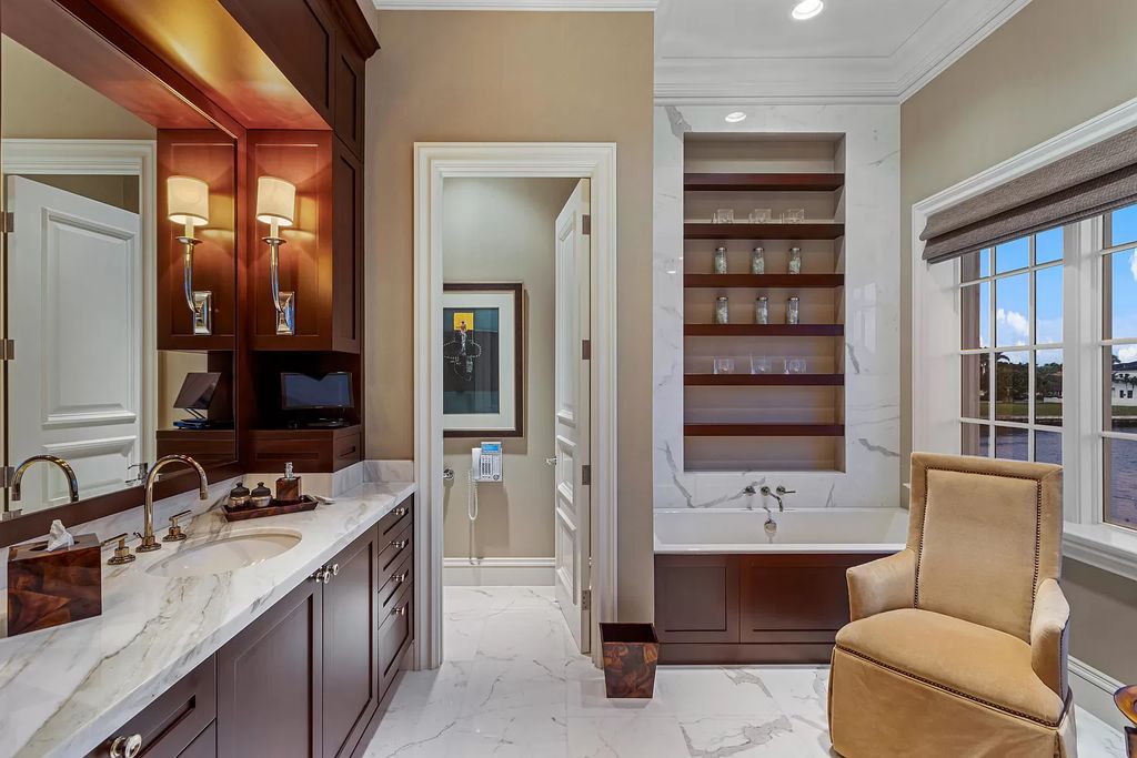 Crafted by Frankel Estate Homes, designed by Carlos Martin Architects, and styled by Marc-Michaels, this 6-bedroom, 10-bathroom mansion showcases an elegant staircase, grand salon, modern kitchen, and a lavish primary suite with waterfront vistas.