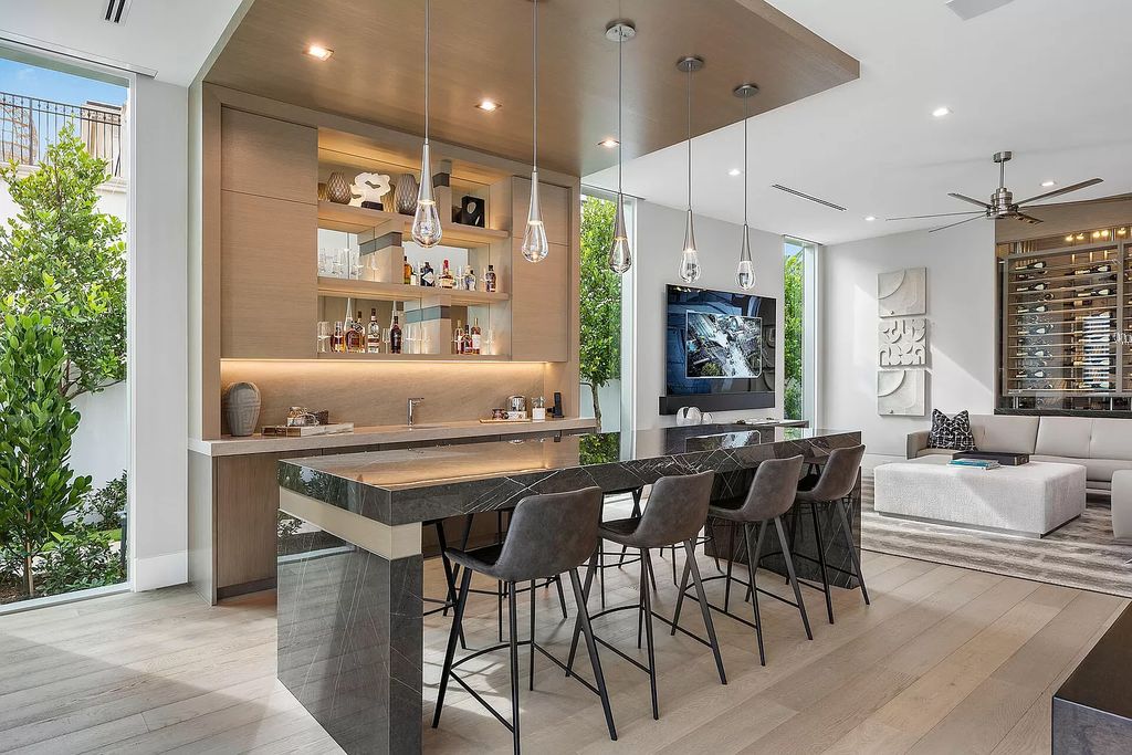 This waterfront haven boasts 6 beds, 9 baths (7 full, 2 half), and a spacious 8,921 square feet living space. Positioned on a premier Intracoastal lot, the property provides stunning water views, a private dock, and 104' of waterfrontage.