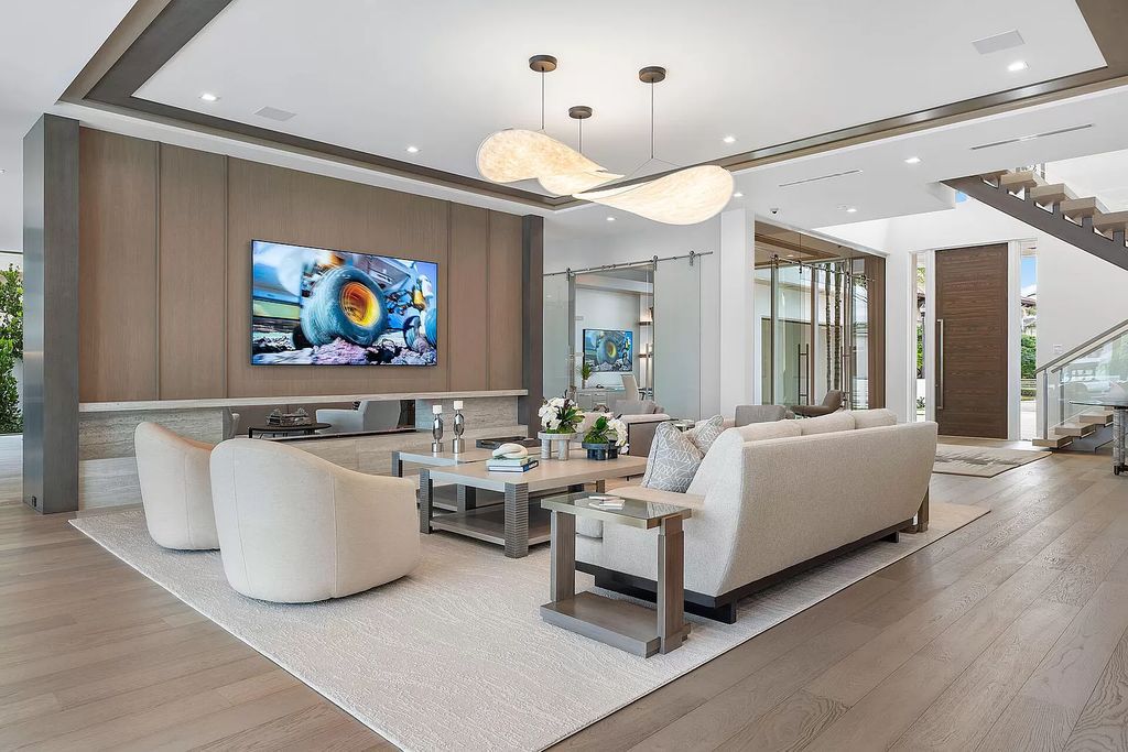 This waterfront haven boasts 6 beds, 9 baths (7 full, 2 half), and a spacious 8,921 square feet living space. Positioned on a premier Intracoastal lot, the property provides stunning water views, a private dock, and 104' of waterfrontage.