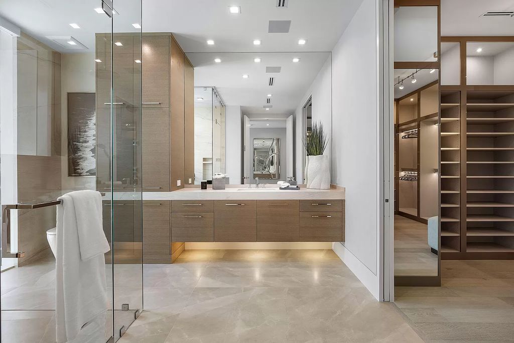 This waterfront haven boasts 6 beds, 9 baths (7 full, 2 half), and a spacious 8,921 square feet living space. Positioned on a premier Intracoastal lot, the property provides stunning water views, a private dock, and 104' of waterfrontage.