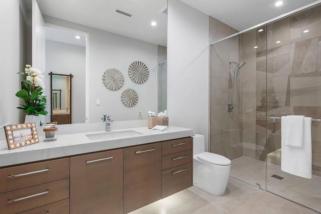 This waterfront haven boasts 6 beds, 9 baths (7 full, 2 half), and a spacious 8,921 square feet living space. Positioned on a premier Intracoastal lot, the property provides stunning water views, a private dock, and 104' of waterfrontage.