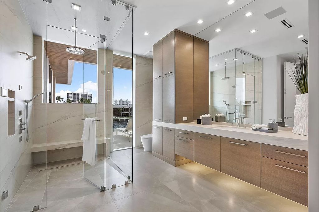 This waterfront haven boasts 6 beds, 9 baths (7 full, 2 half), and a spacious 8,921 square feet living space. Positioned on a premier Intracoastal lot, the property provides stunning water views, a private dock, and 104' of waterfrontage.