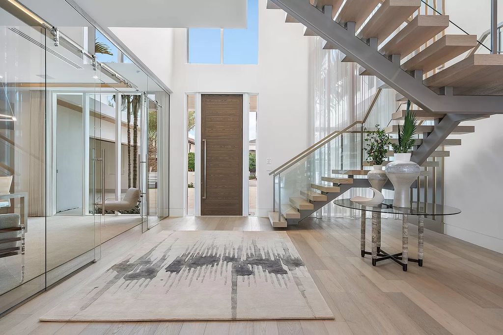 This waterfront haven boasts 6 beds, 9 baths (7 full, 2 half), and a spacious 8,921 square feet living space. Positioned on a premier Intracoastal lot, the property provides stunning water views, a private dock, and 104' of waterfrontage.