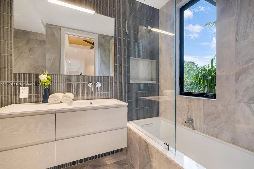 Discover the epitome of tropical luxury living at the Sir Crawford residence in Miami, perfectly situated near top schools and Grove amenities.
