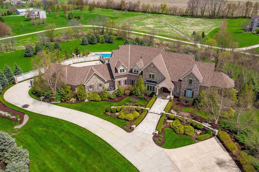 15718 Viberg Road Home in Leo, Indiana. Explore this elegant estate nestled on 11 manicured acres in Leo, IN. With over 11,000 square feet of living space, Venetian plaster walls, hand-scraped wood floors, and custom features throughout, this home offers the ultimate retreat.