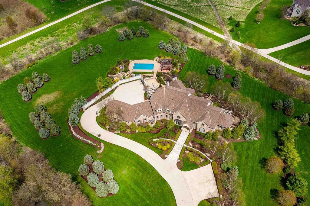 15718 Viberg Road Home in Leo, Indiana. Explore this elegant estate nestled on 11 manicured acres in Leo, IN. With over 11,000 square feet of living space, Venetian plaster walls, hand-scraped wood floors, and custom features throughout, this home offers the ultimate retreat.