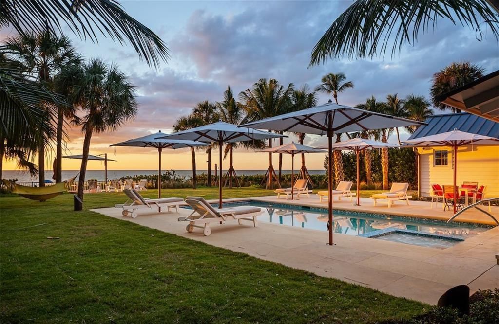 Nestled on nearly half an acre of prime beachfront land in Olde Naples, this exceptional home seamlessly blends coastal elegance with timeless craftsmanship.