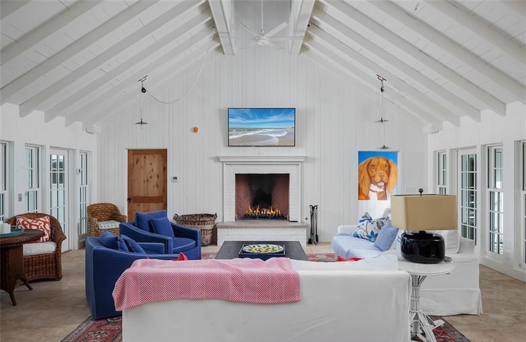 Nestled on nearly half an acre of prime beachfront land in Olde Naples, this exceptional home seamlessly blends coastal elegance with timeless craftsmanship.