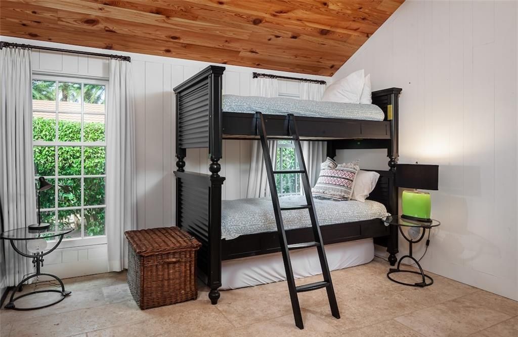 Nestled on nearly half an acre of prime beachfront land in Olde Naples, this exceptional home seamlessly blends coastal elegance with timeless craftsmanship.