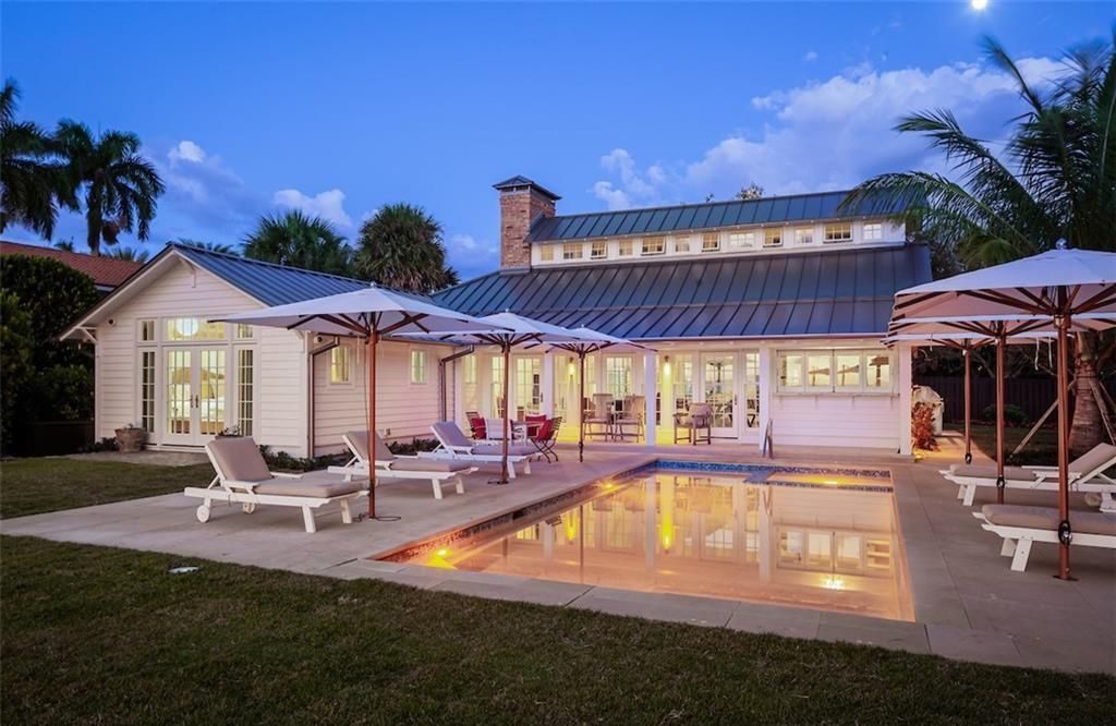 Nestled on nearly half an acre of prime beachfront land in Olde Naples, this exceptional home seamlessly blends coastal elegance with timeless craftsmanship.