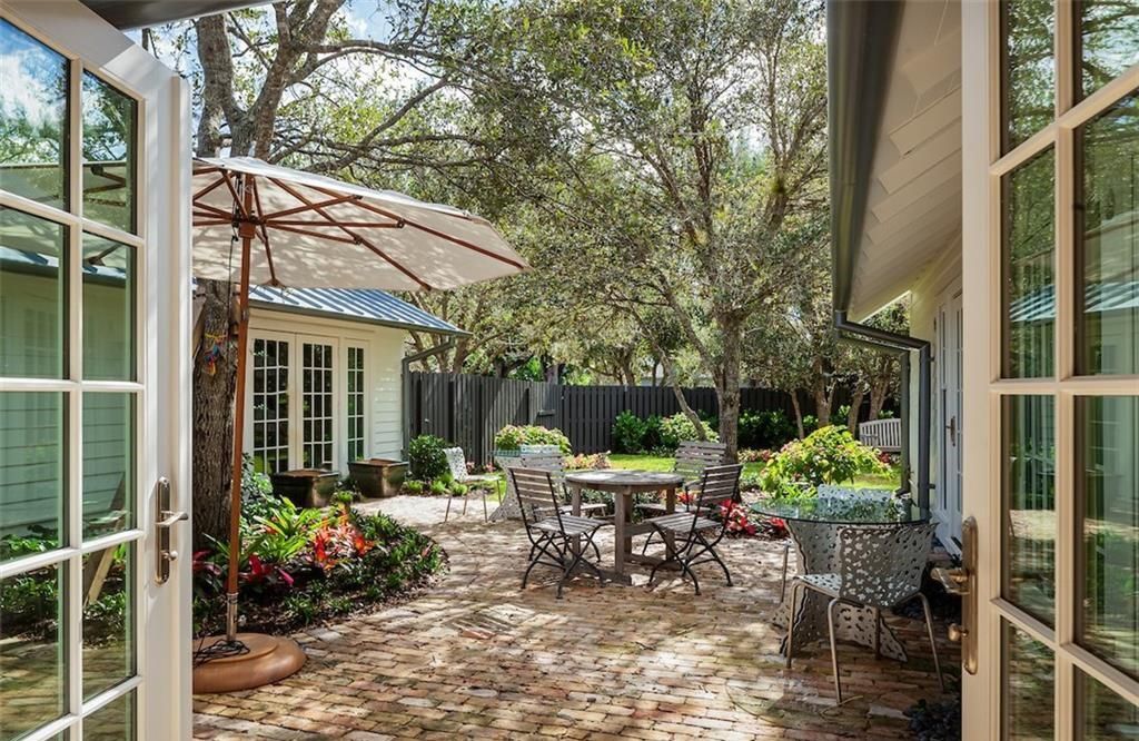 Nestled on nearly half an acre of prime beachfront land in Olde Naples, this exceptional home seamlessly blends coastal elegance with timeless craftsmanship.