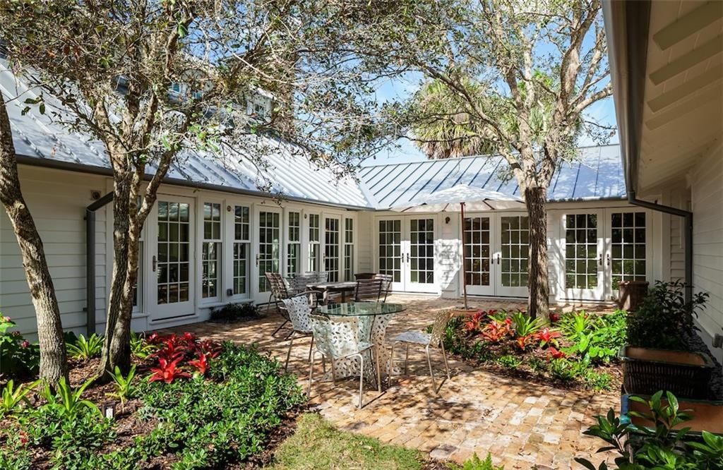 Nestled on nearly half an acre of prime beachfront land in Olde Naples, this exceptional home seamlessly blends coastal elegance with timeless craftsmanship.