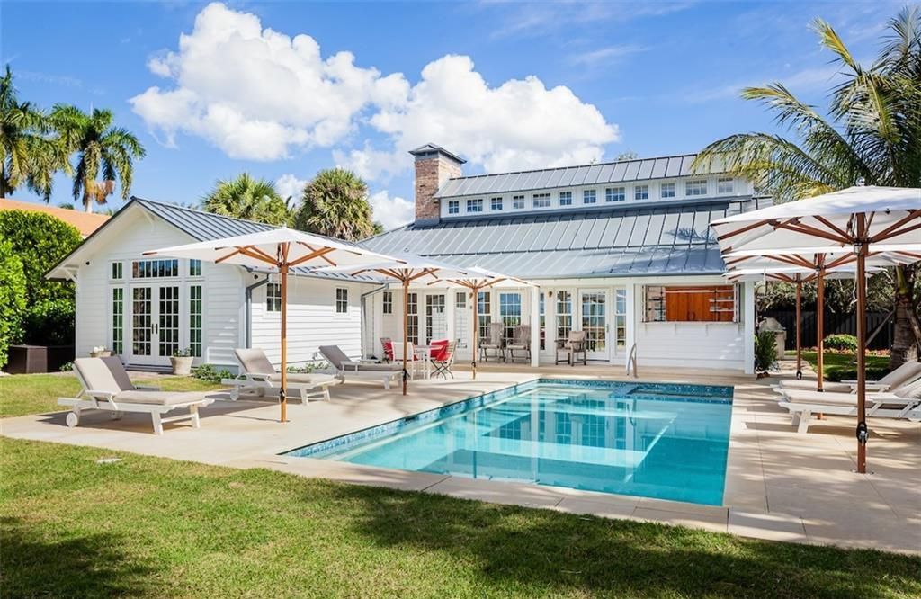 Nestled on nearly half an acre of prime beachfront land in Olde Naples, this exceptional home seamlessly blends coastal elegance with timeless craftsmanship.