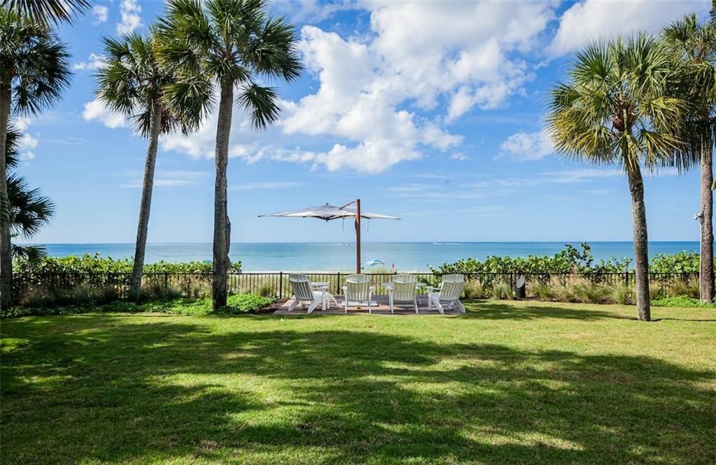 Nestled on nearly half an acre of prime beachfront land in Olde Naples, this exceptional home seamlessly blends coastal elegance with timeless craftsmanship.