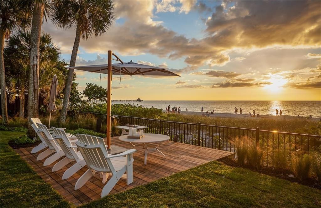 Nestled on nearly half an acre of prime beachfront land in Olde Naples, this exceptional home seamlessly blends coastal elegance with timeless craftsmanship.