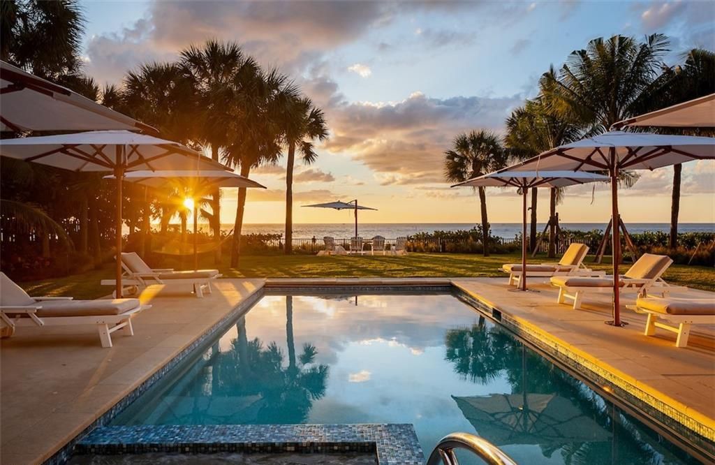 Nestled on nearly half an acre of prime beachfront land in Olde Naples, this exceptional home seamlessly blends coastal elegance with timeless craftsmanship.