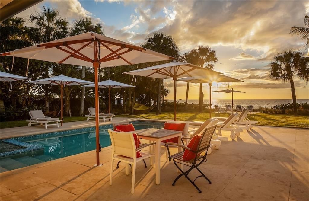 Nestled on nearly half an acre of prime beachfront land in Olde Naples, this exceptional home seamlessly blends coastal elegance with timeless craftsmanship.