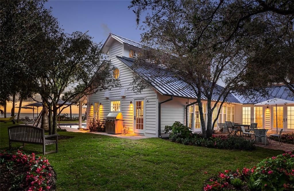 Nestled on nearly half an acre of prime beachfront land in Olde Naples, this exceptional home seamlessly blends coastal elegance with timeless craftsmanship.