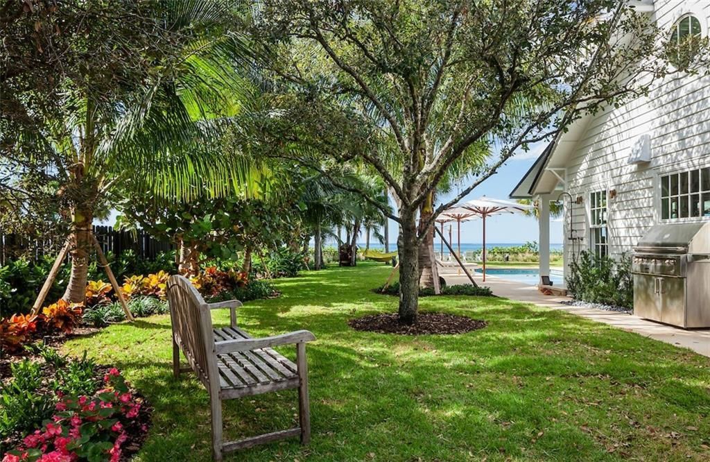 Nestled on nearly half an acre of prime beachfront land in Olde Naples, this exceptional home seamlessly blends coastal elegance with timeless craftsmanship.