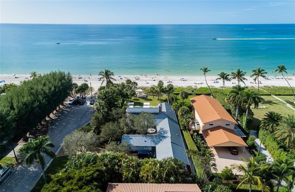 Nestled on nearly half an acre of prime beachfront land in Olde Naples, this exceptional home seamlessly blends coastal elegance with timeless craftsmanship.