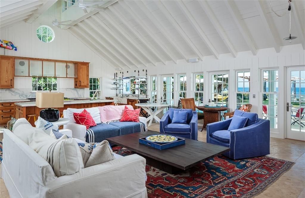 Nestled on nearly half an acre of prime beachfront land in Olde Naples, this exceptional home seamlessly blends coastal elegance with timeless craftsmanship.