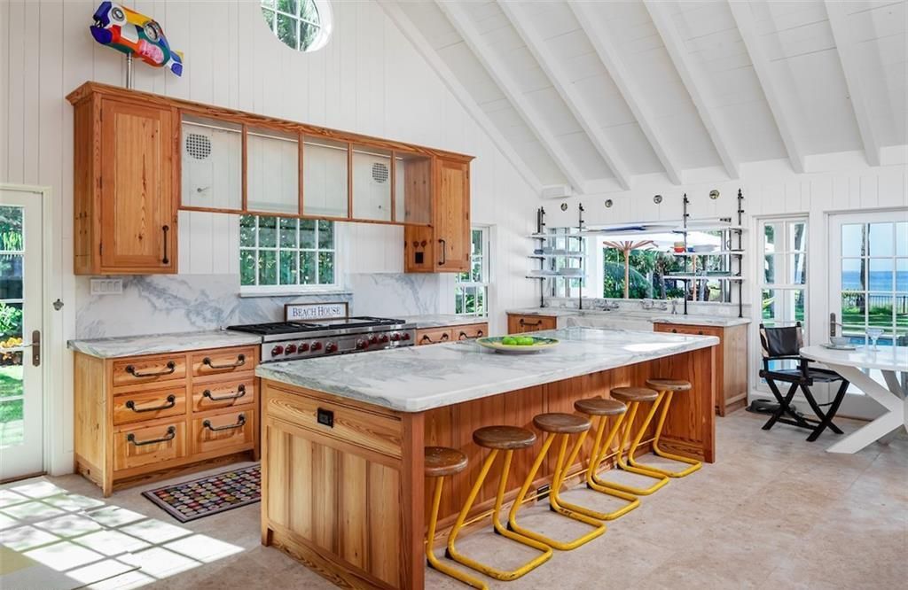 Nestled on nearly half an acre of prime beachfront land in Olde Naples, this exceptional home seamlessly blends coastal elegance with timeless craftsmanship.