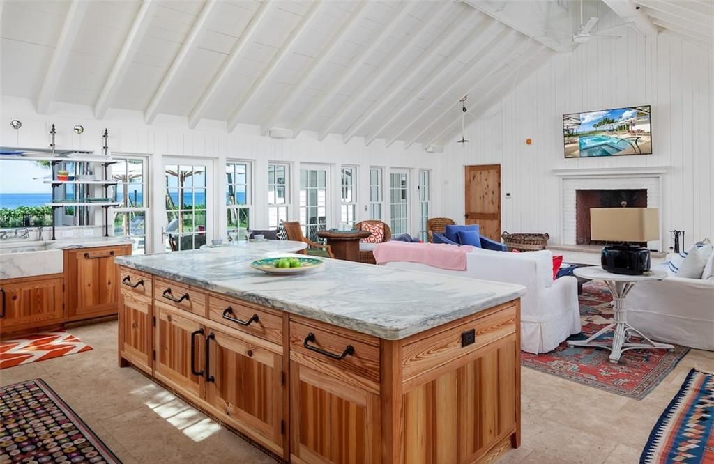 Nestled on nearly half an acre of prime beachfront land in Olde Naples, this exceptional home seamlessly blends coastal elegance with timeless craftsmanship.