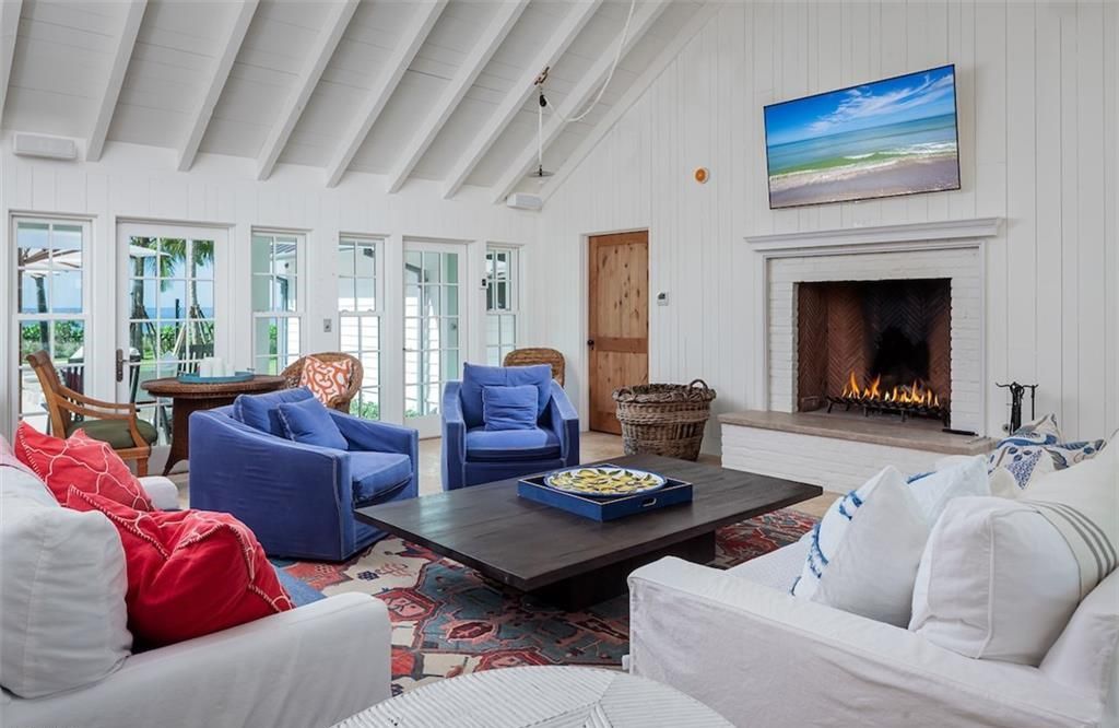 Nestled on nearly half an acre of prime beachfront land in Olde Naples, this exceptional home seamlessly blends coastal elegance with timeless craftsmanship.