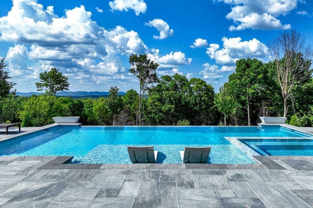 9252 Lehigh Drive Home in Brentwood, Tennessee. Step into luxury living at its finest with this stunning transitional home nestled on a private 3.5-acre lot in Brentwood. Enjoy breathtaking views of the surrounding hillsides from every angle, complemented by Marie-Joe Bouffard’s captivating interior design. 