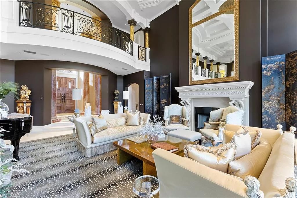 Welcome to the epitome of luxury living at 7310 Tilden Ln in Bay Colony Shores, Naples, Florida. This magnificent estate boasts over 10,000 square feet of meticulously crafted living space, featuring 6 palatial bedrooms with en-suite bathrooms, two additional half baths, and exquisite architectural details throughout.