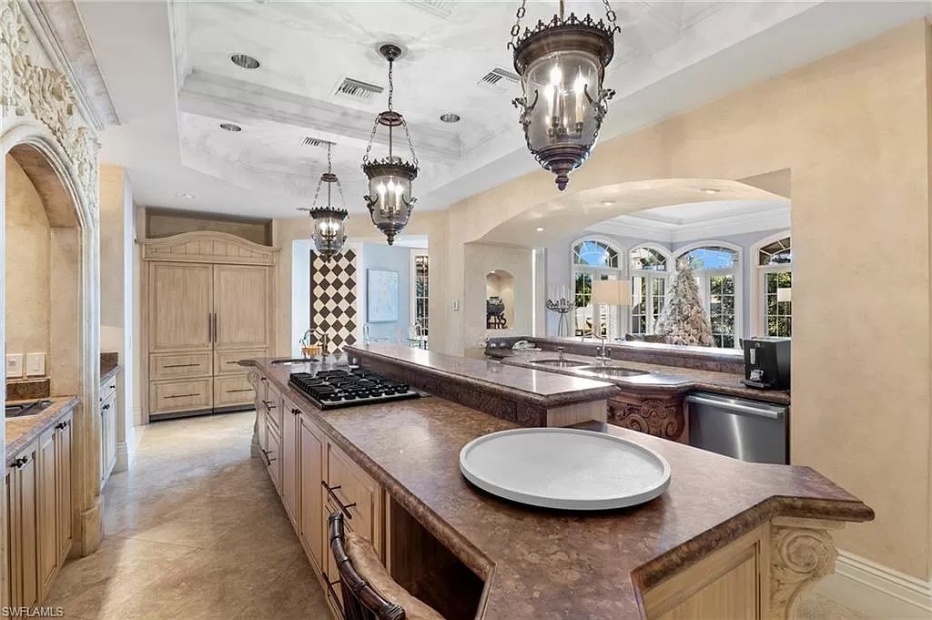 Welcome to the epitome of luxury living at 7310 Tilden Ln in Bay Colony Shores, Naples, Florida. This magnificent estate boasts over 10,000 square feet of meticulously crafted living space, featuring 6 palatial bedrooms with en-suite bathrooms, two additional half baths, and exquisite architectural details throughout.