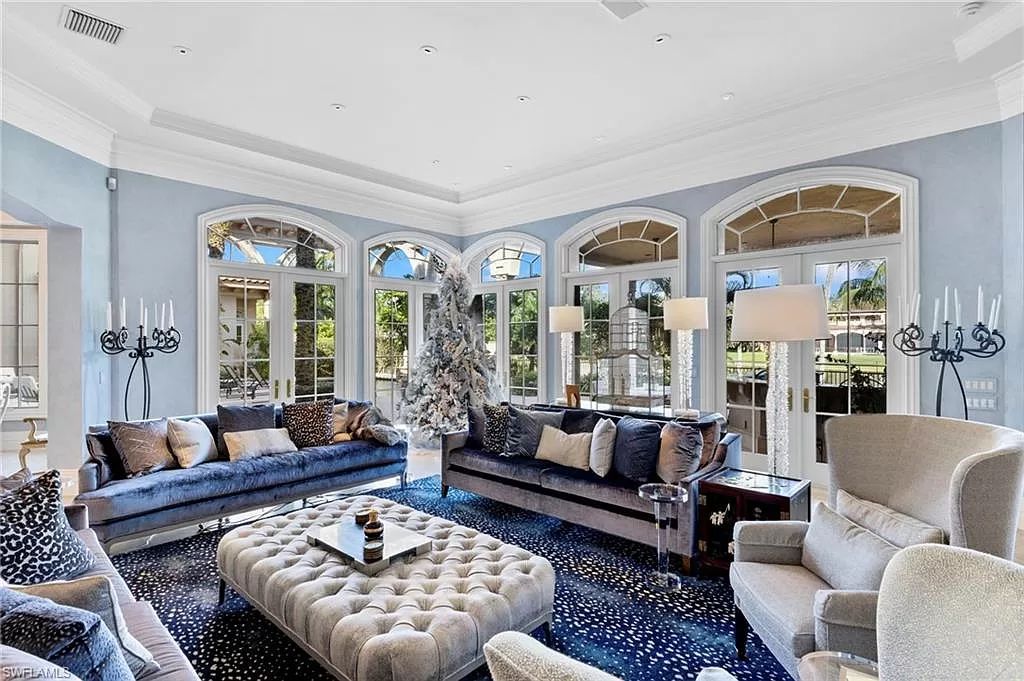 Welcome to the epitome of luxury living at 7310 Tilden Ln in Bay Colony Shores, Naples, Florida. This magnificent estate boasts over 10,000 square feet of meticulously crafted living space, featuring 6 palatial bedrooms with en-suite bathrooms, two additional half baths, and exquisite architectural details throughout.