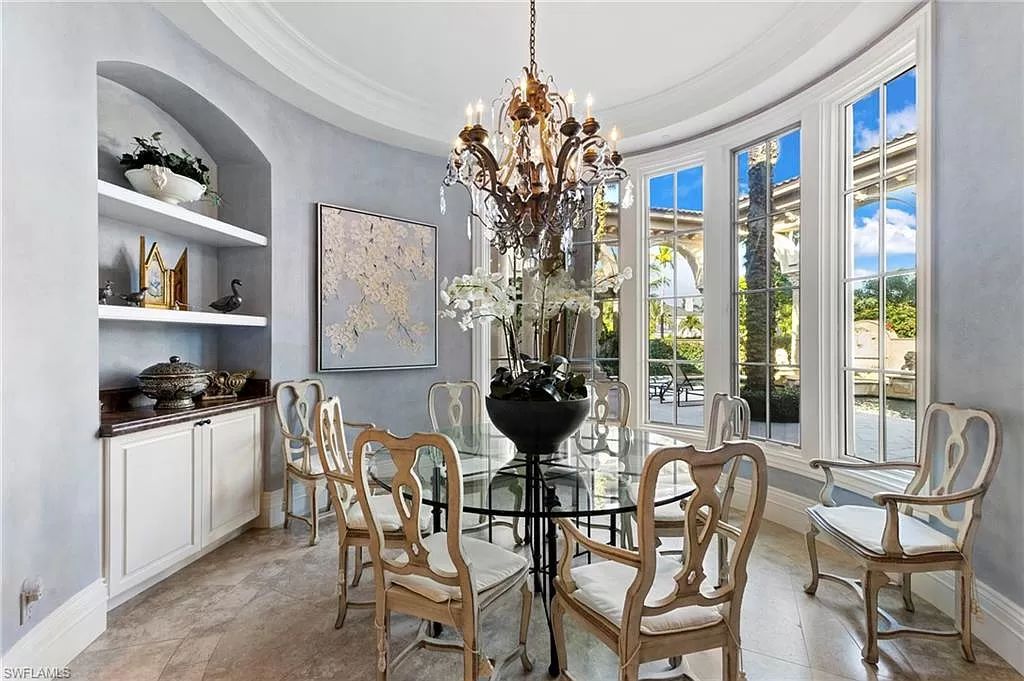 Welcome to the epitome of luxury living at 7310 Tilden Ln in Bay Colony Shores, Naples, Florida. This magnificent estate boasts over 10,000 square feet of meticulously crafted living space, featuring 6 palatial bedrooms with en-suite bathrooms, two additional half baths, and exquisite architectural details throughout.