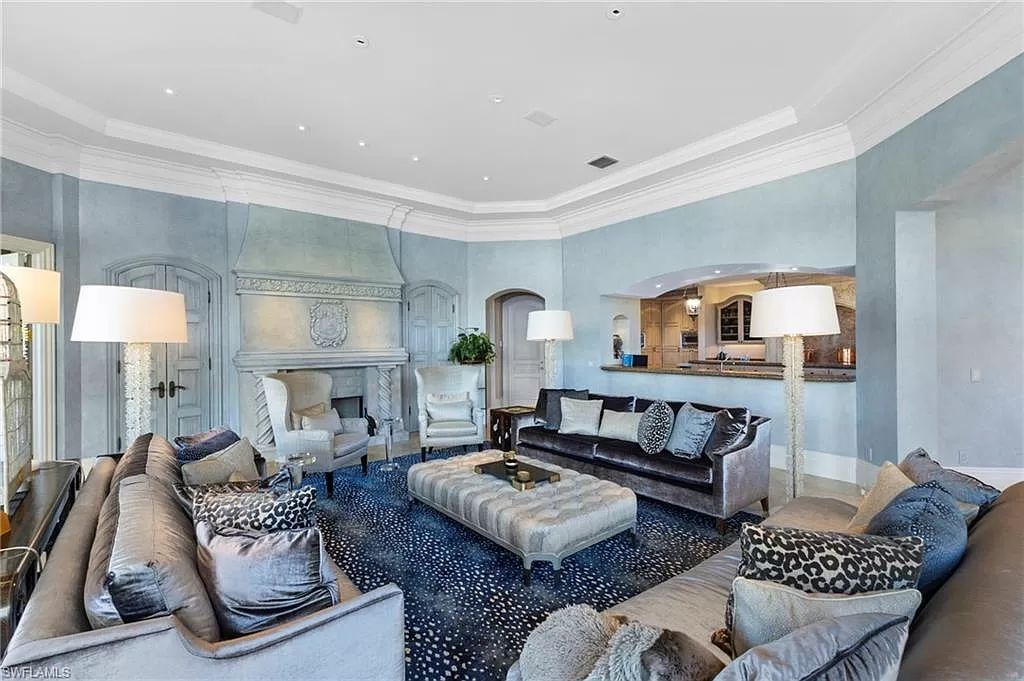Welcome to the epitome of luxury living at 7310 Tilden Ln in Bay Colony Shores, Naples, Florida. This magnificent estate boasts over 10,000 square feet of meticulously crafted living space, featuring 6 palatial bedrooms with en-suite bathrooms, two additional half baths, and exquisite architectural details throughout.