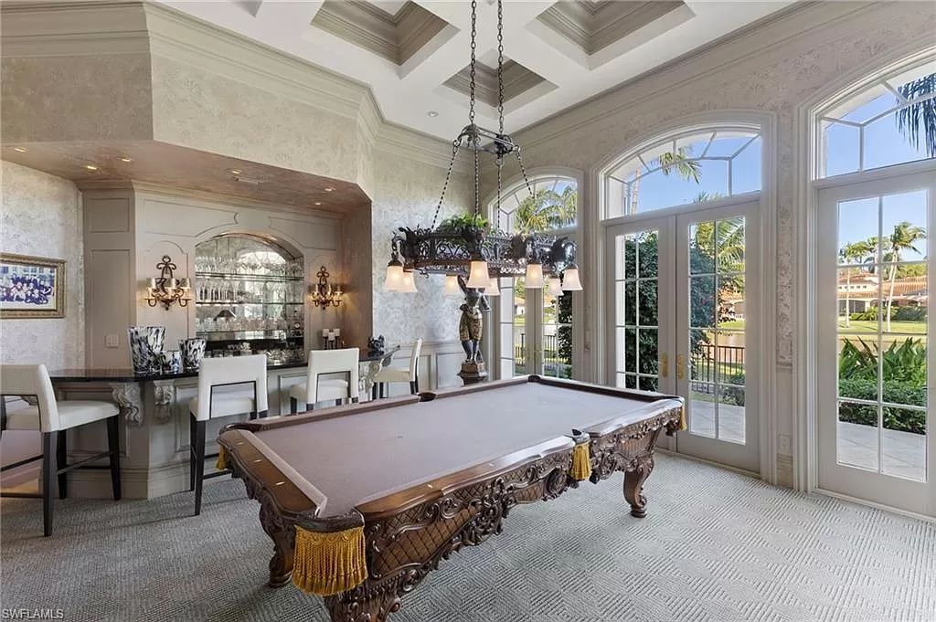 Welcome to the epitome of luxury living at 7310 Tilden Ln in Bay Colony Shores, Naples, Florida. This magnificent estate boasts over 10,000 square feet of meticulously crafted living space, featuring 6 palatial bedrooms with en-suite bathrooms, two additional half baths, and exquisite architectural details throughout.