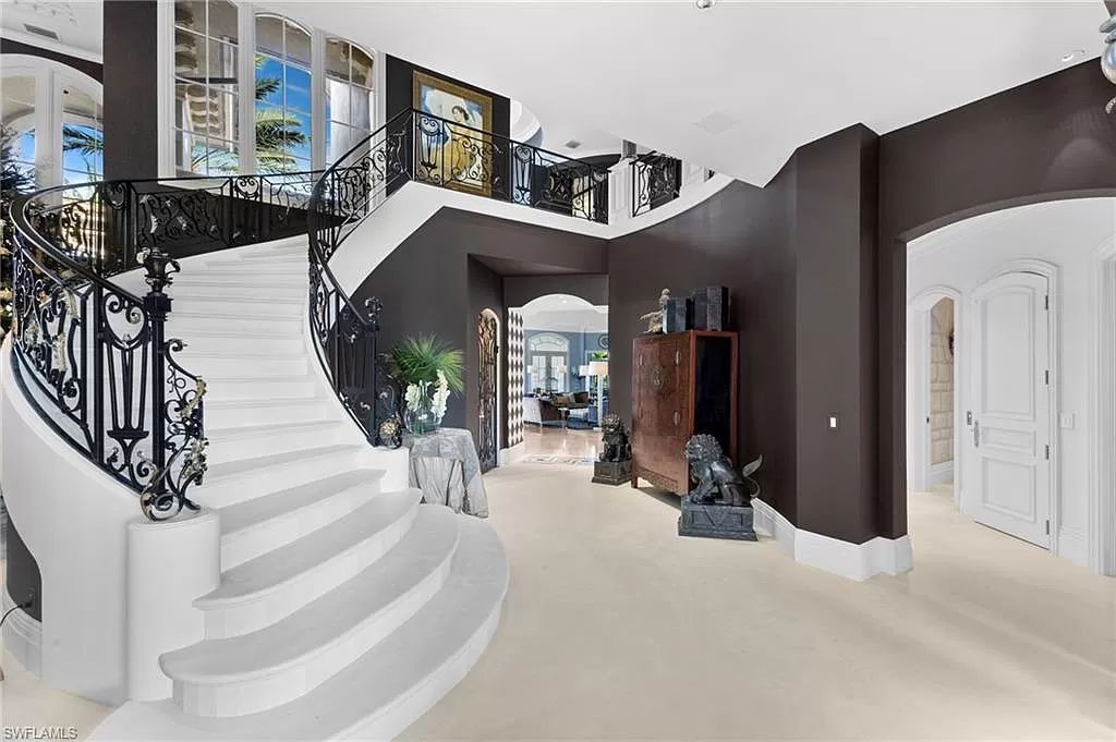 Welcome to the epitome of luxury living at 7310 Tilden Ln in Bay Colony Shores, Naples, Florida. This magnificent estate boasts over 10,000 square feet of meticulously crafted living space, featuring 6 palatial bedrooms with en-suite bathrooms, two additional half baths, and exquisite architectural details throughout.