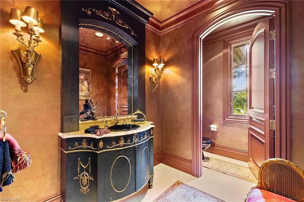 Welcome to the epitome of luxury living at 7310 Tilden Ln in Bay Colony Shores, Naples, Florida. This magnificent estate boasts over 10,000 square feet of meticulously crafted living space, featuring 6 palatial bedrooms with en-suite bathrooms, two additional half baths, and exquisite architectural details throughout.