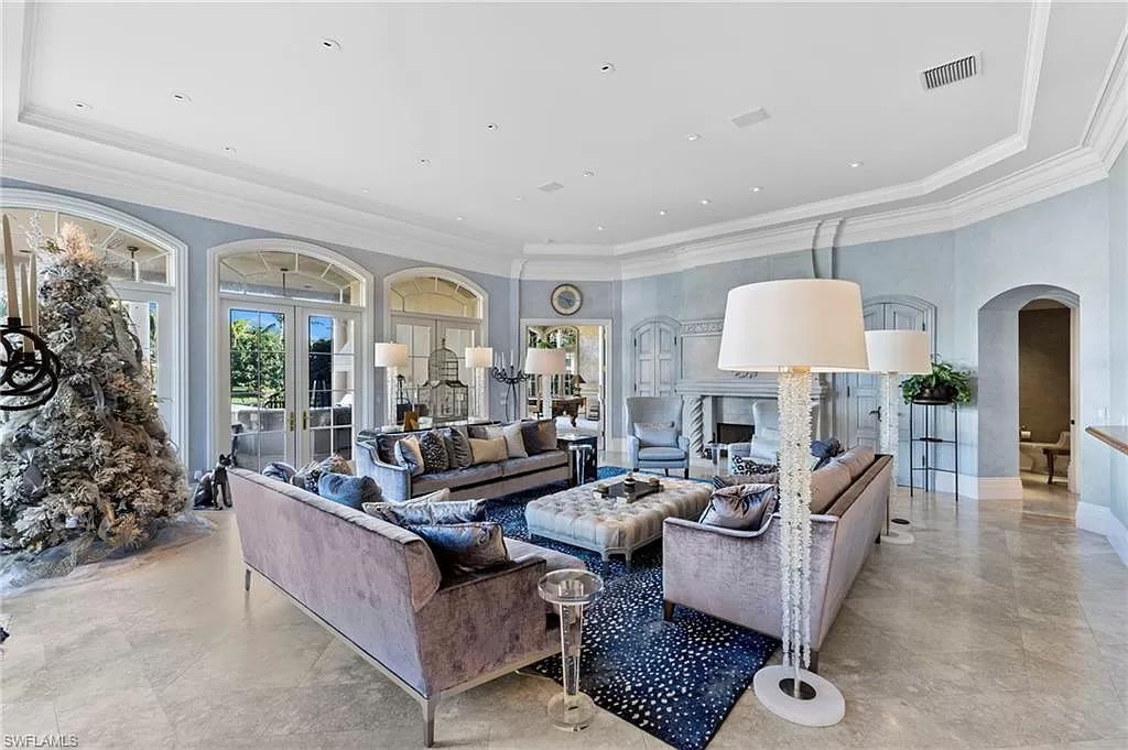 Welcome to the epitome of luxury living at 7310 Tilden Ln in Bay Colony Shores, Naples, Florida. This magnificent estate boasts over 10,000 square feet of meticulously crafted living space, featuring 6 palatial bedrooms with en-suite bathrooms, two additional half baths, and exquisite architectural details throughout.