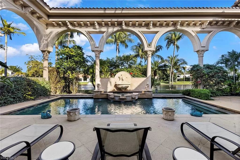 Welcome to the epitome of luxury living at 7310 Tilden Ln in Bay Colony Shores, Naples, Florida. This magnificent estate boasts over 10,000 square feet of meticulously crafted living space, featuring 6 palatial bedrooms with en-suite bathrooms, two additional half baths, and exquisite architectural details throughout.