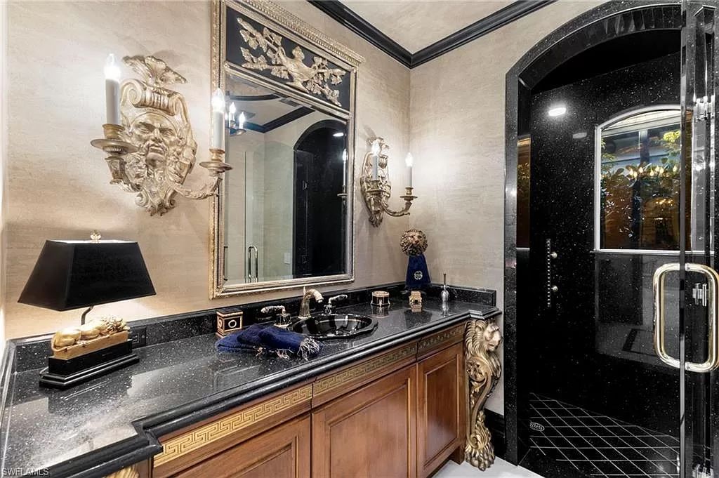 Welcome to the epitome of luxury living at 7310 Tilden Ln in Bay Colony Shores, Naples, Florida. This magnificent estate boasts over 10,000 square feet of meticulously crafted living space, featuring 6 palatial bedrooms with en-suite bathrooms, two additional half baths, and exquisite architectural details throughout.