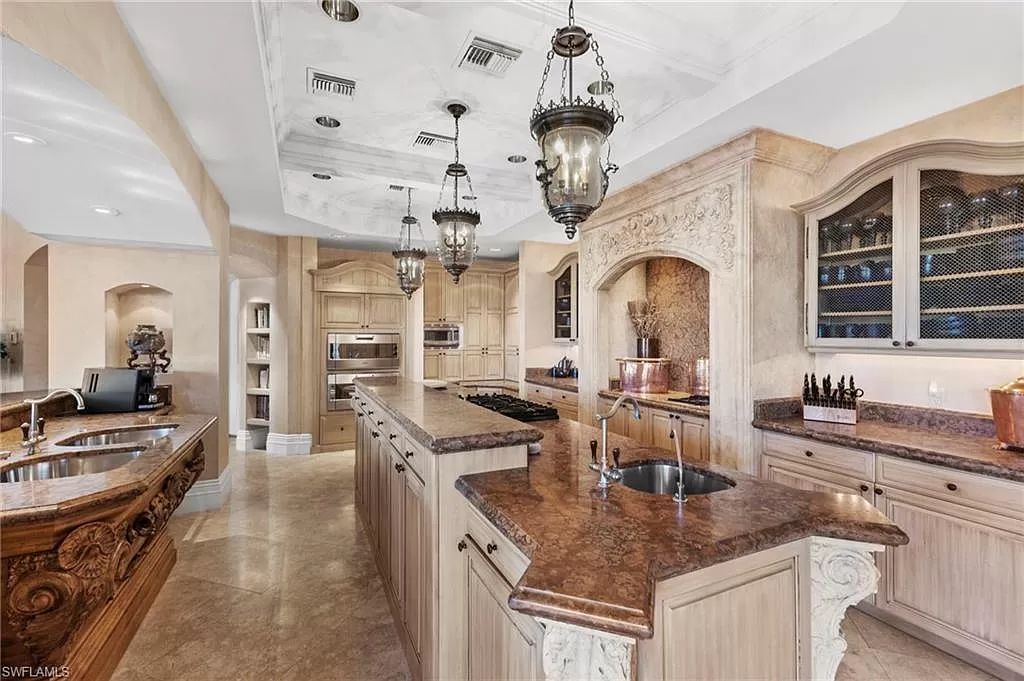 Welcome to the epitome of luxury living at 7310 Tilden Ln in Bay Colony Shores, Naples, Florida. This magnificent estate boasts over 10,000 square feet of meticulously crafted living space, featuring 6 palatial bedrooms with en-suite bathrooms, two additional half baths, and exquisite architectural details throughout.