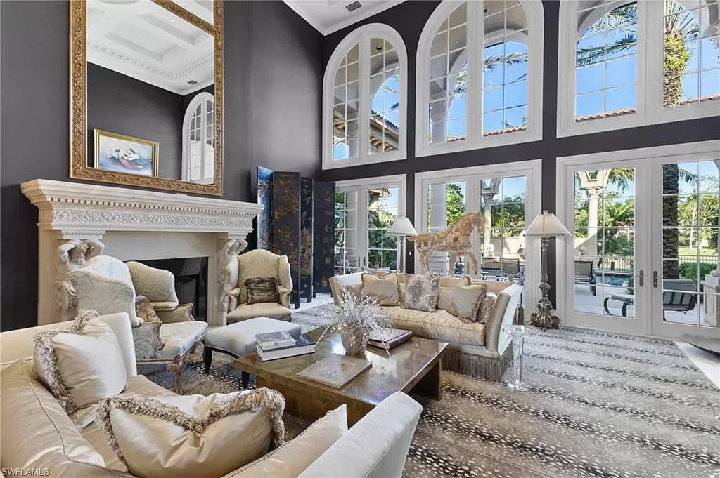 Welcome to the epitome of luxury living at 7310 Tilden Ln in Bay Colony Shores, Naples, Florida. This magnificent estate boasts over 10,000 square feet of meticulously crafted living space, featuring 6 palatial bedrooms with en-suite bathrooms, two additional half baths, and exquisite architectural details throughout.