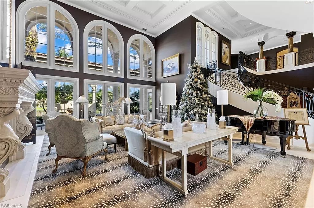 Welcome to the epitome of luxury living at 7310 Tilden Ln in Bay Colony Shores, Naples, Florida. This magnificent estate boasts over 10,000 square feet of meticulously crafted living space, featuring 6 palatial bedrooms with en-suite bathrooms, two additional half baths, and exquisite architectural details throughout.
