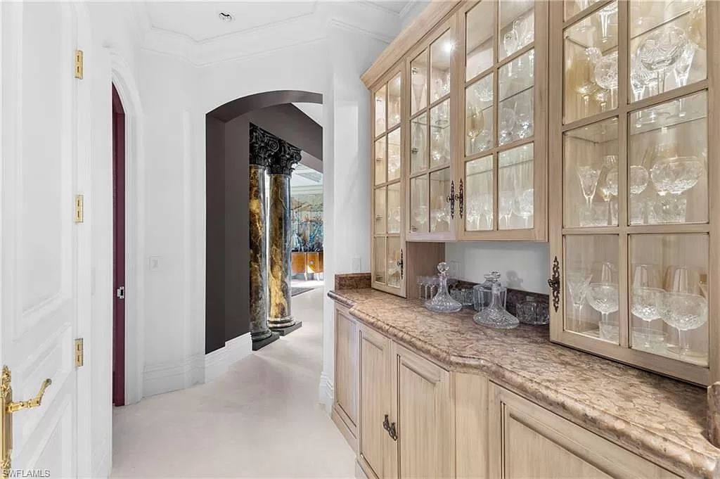 Welcome to the epitome of luxury living at 7310 Tilden Ln in Bay Colony Shores, Naples, Florida. This magnificent estate boasts over 10,000 square feet of meticulously crafted living space, featuring 6 palatial bedrooms with en-suite bathrooms, two additional half baths, and exquisite architectural details throughout.