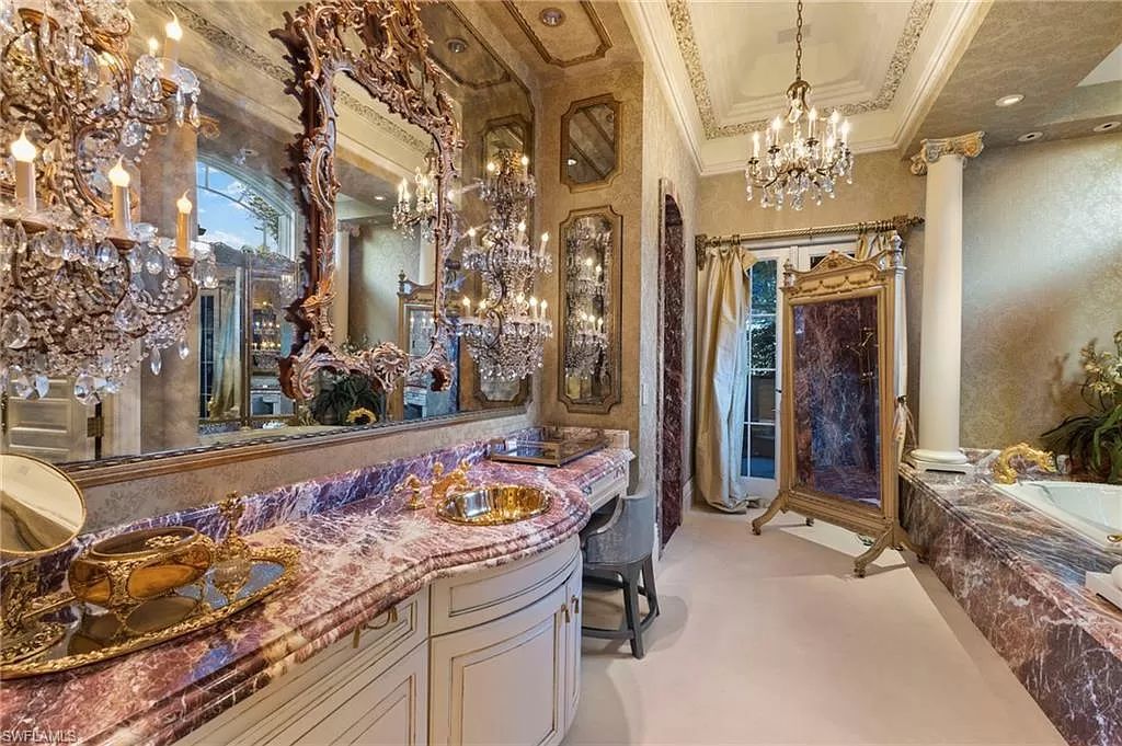 Welcome to the epitome of luxury living at 7310 Tilden Ln in Bay Colony Shores, Naples, Florida. This magnificent estate boasts over 10,000 square feet of meticulously crafted living space, featuring 6 palatial bedrooms with en-suite bathrooms, two additional half baths, and exquisite architectural details throughout.