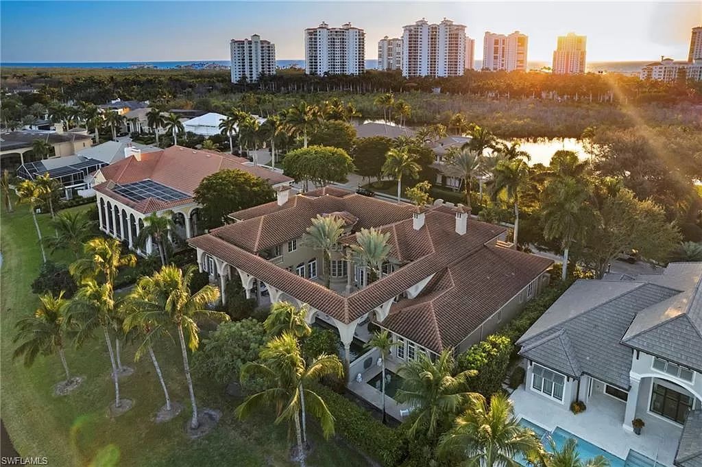 Welcome to the epitome of luxury living at 7310 Tilden Ln in Bay Colony Shores, Naples, Florida. This magnificent estate boasts over 10,000 square feet of meticulously crafted living space, featuring 6 palatial bedrooms with en-suite bathrooms, two additional half baths, and exquisite architectural details throughout.