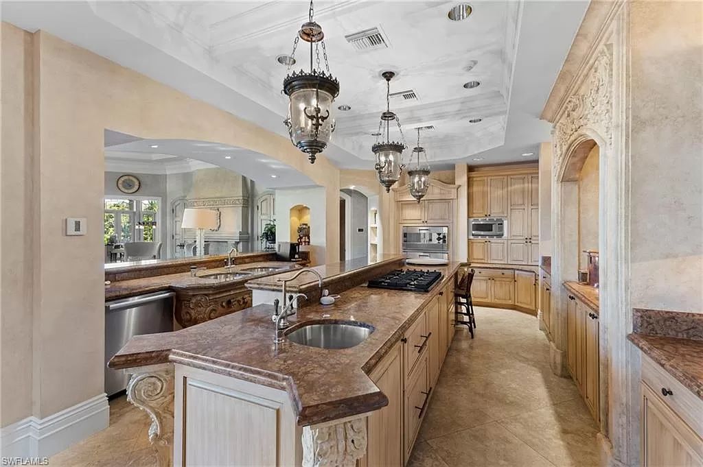 Welcome to the epitome of luxury living at 7310 Tilden Ln in Bay Colony Shores, Naples, Florida. This magnificent estate boasts over 10,000 square feet of meticulously crafted living space, featuring 6 palatial bedrooms with en-suite bathrooms, two additional half baths, and exquisite architectural details throughout.