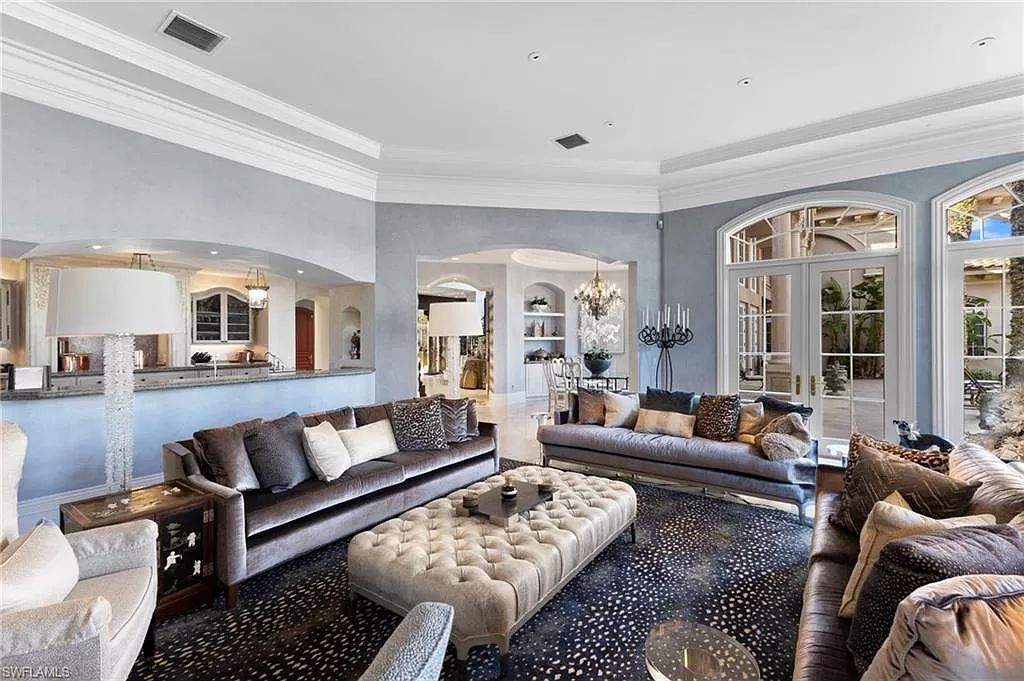 Welcome to the epitome of luxury living at 7310 Tilden Ln in Bay Colony Shores, Naples, Florida. This magnificent estate boasts over 10,000 square feet of meticulously crafted living space, featuring 6 palatial bedrooms with en-suite bathrooms, two additional half baths, and exquisite architectural details throughout.