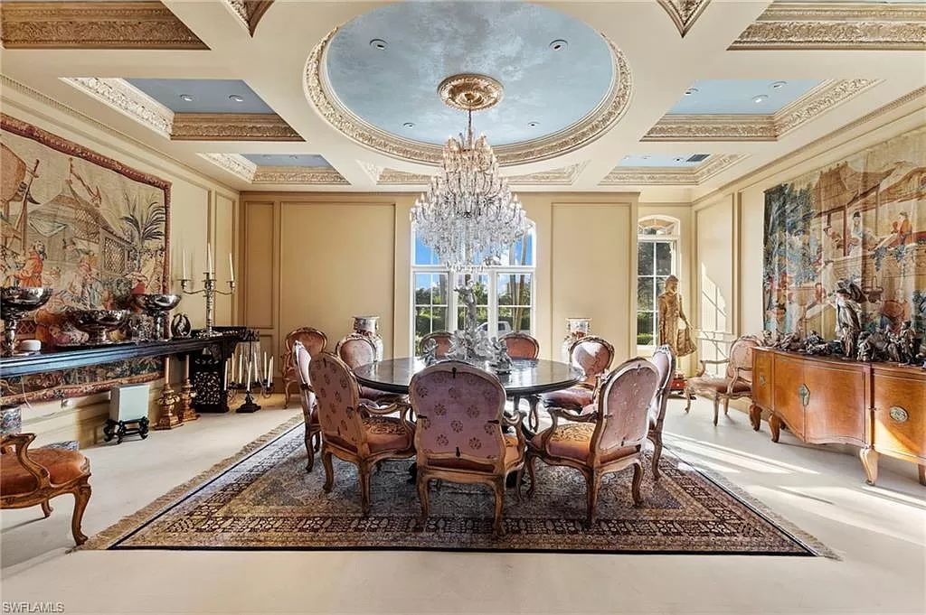 Welcome to the epitome of luxury living at 7310 Tilden Ln in Bay Colony Shores, Naples, Florida. This magnificent estate boasts over 10,000 square feet of meticulously crafted living space, featuring 6 palatial bedrooms with en-suite bathrooms, two additional half baths, and exquisite architectural details throughout.
