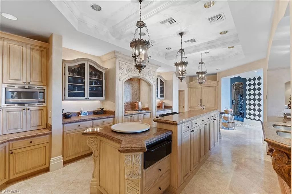 Welcome to the epitome of luxury living at 7310 Tilden Ln in Bay Colony Shores, Naples, Florida. This magnificent estate boasts over 10,000 square feet of meticulously crafted living space, featuring 6 palatial bedrooms with en-suite bathrooms, two additional half baths, and exquisite architectural details throughout.